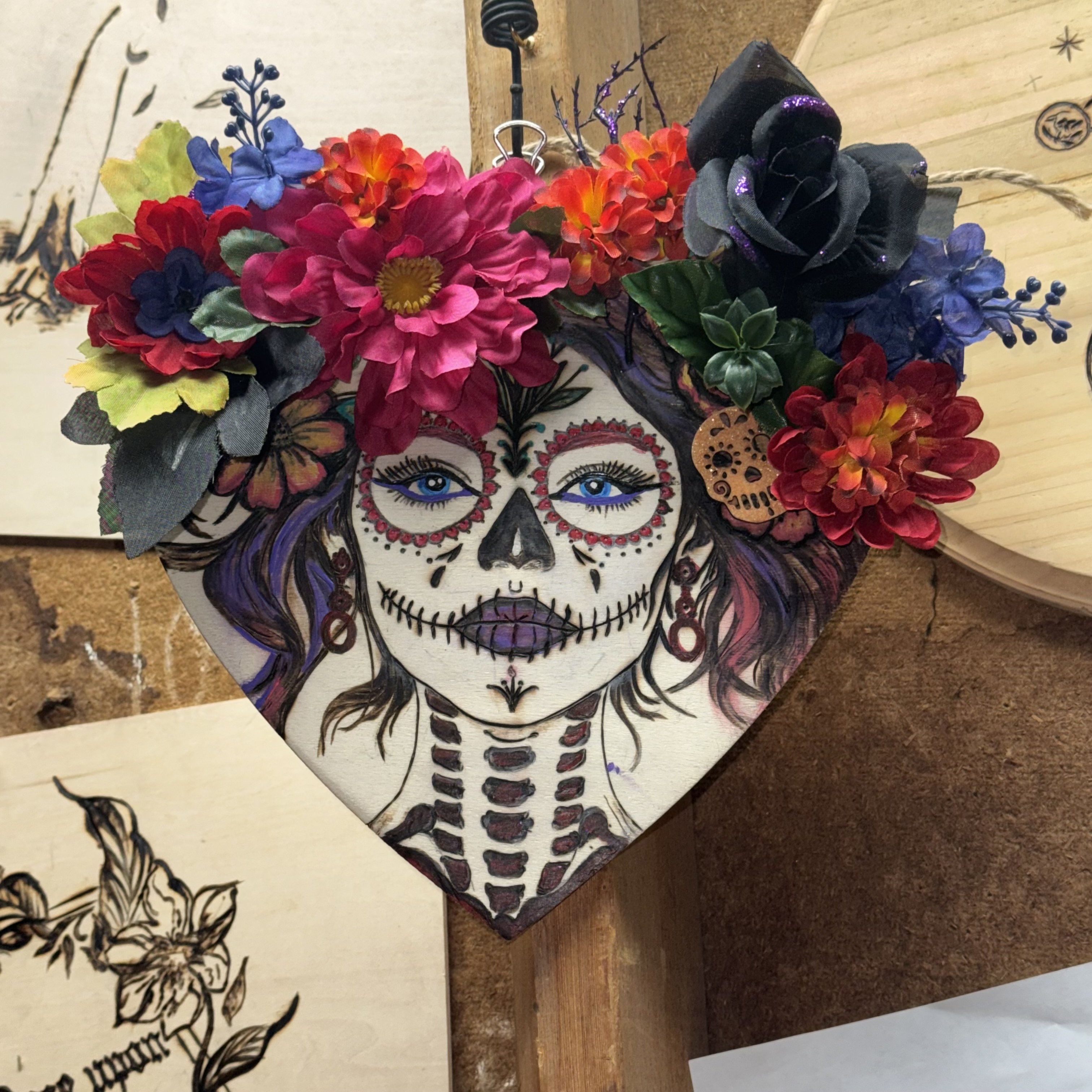 Ofrenda — finished Día de los Muertos woodburning on a heart-shaped panel with a silk flower crown