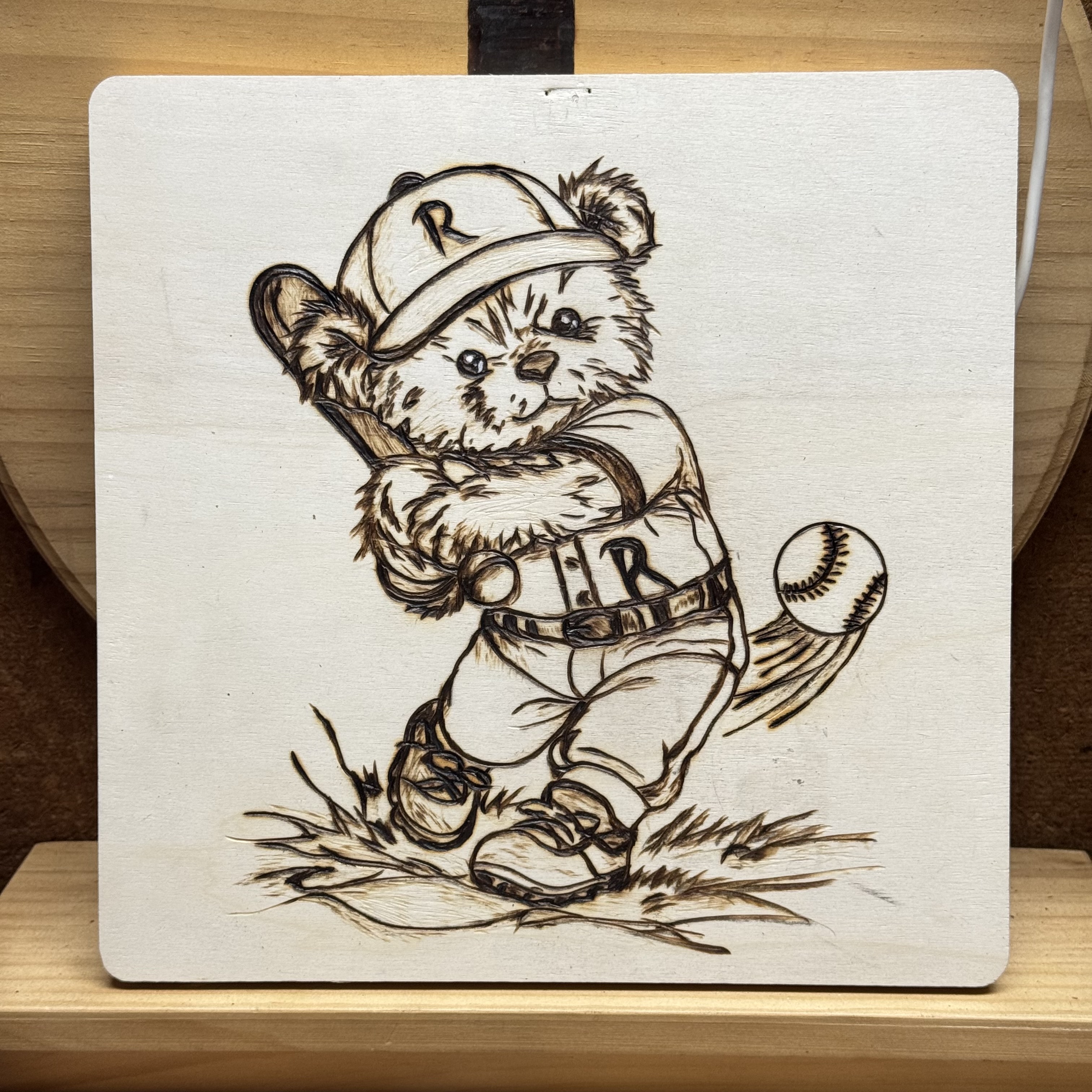 Teddy bears playing sports, woodburning