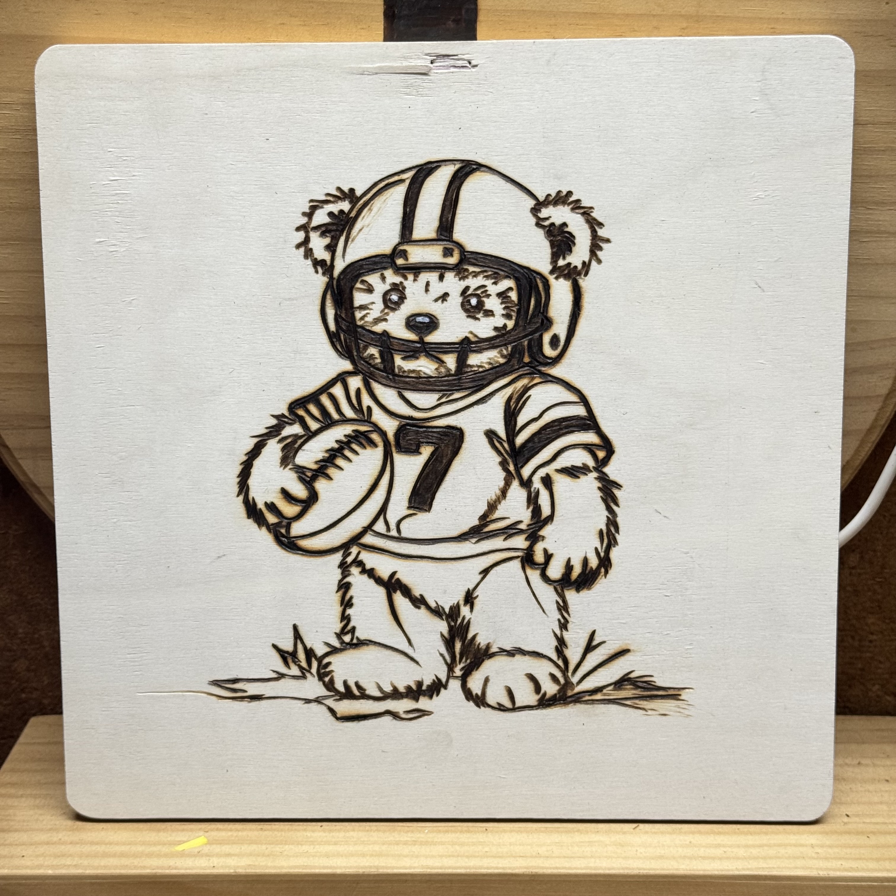 Teddy bears playing sports, woodburning