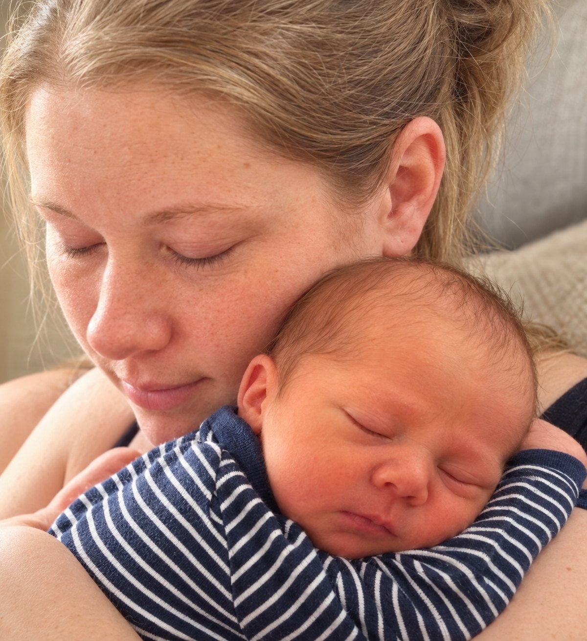 The original photo — Sarah holding baby Dev, asleep on her shoulder in a striped onesie