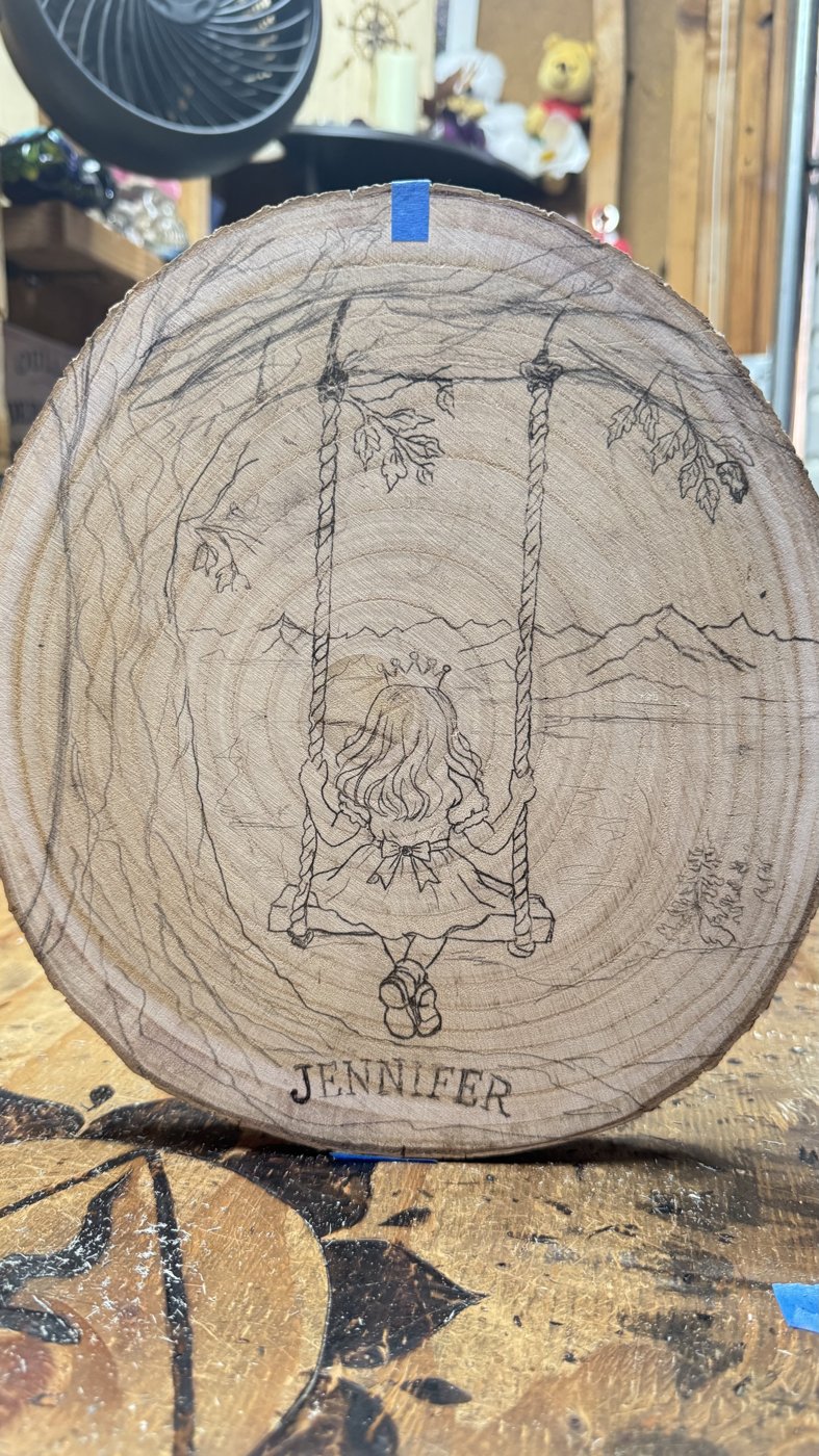 Little Princess — girl in a crown on a tree swing, sketched on a wood round, ready to burn